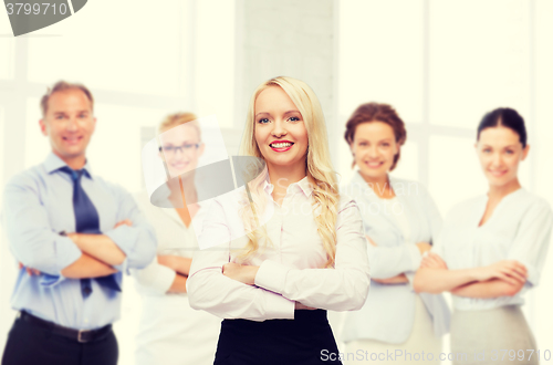 Image of smiling businesswoman or secretary in office