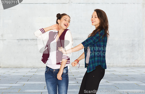 Image of happy smiling pretty teenage girls dancing