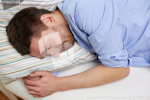 Image of close up of  happy young man sleeping at home