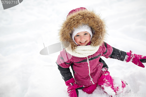 Image of f happy little child or girl with snow in winter