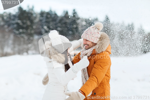 Image of happy couple hugging and laughing in winter