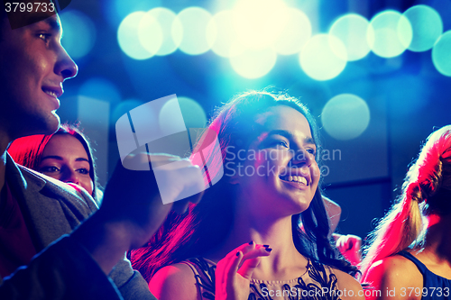 Image of smiling friends dancing in club