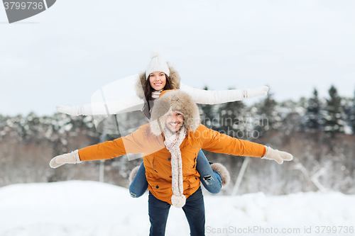 Image of happy couple having fun over winter background