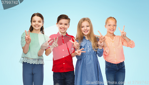 Image of happy boy and girls showing peace hand sign