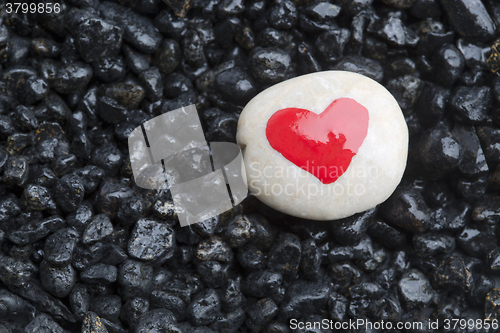 Image of Red heart on white stone