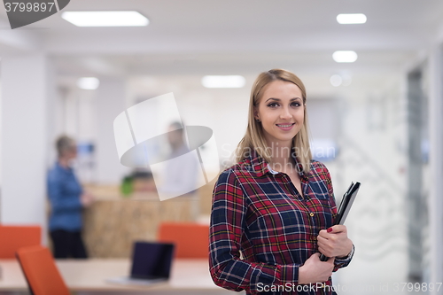 Image of portrait of young business woman at office with team in backgrou