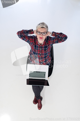 Image of top view of young business woman working on laptop computer