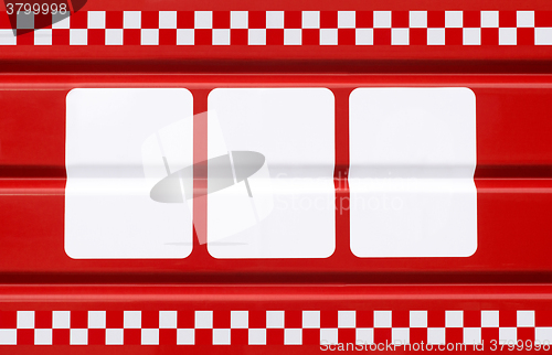 Image of  red metal plate with three white rectangles for symbols