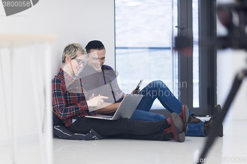 Image of startup business, couple working on laptop computer at office