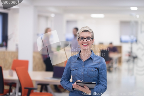 Image of portrait of young business woman at office with team in backgrou