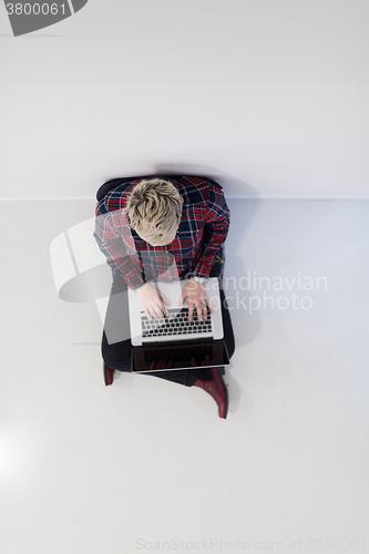Image of top view of young business woman working on laptop computer