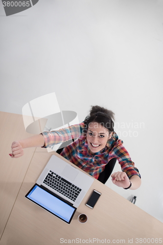 Image of top view of young business woman working on laptop