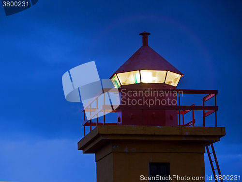 Image of Closeup of the top of an orange lighthouse