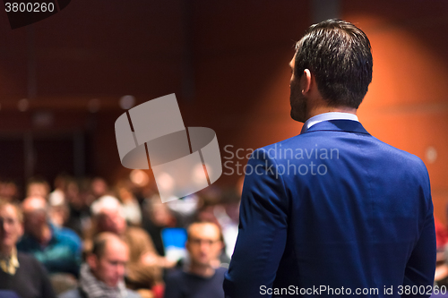 Image of Public speaker giving talk at Business Event.