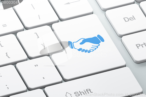 Image of Business concept: Handshake on computer keyboard background