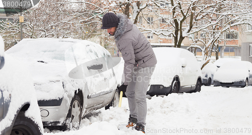 Image of Man shoveling snow in winter.