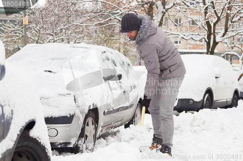 Image of Man shoveling snow in winter.