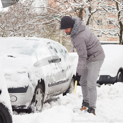 Image of Man shoveling snow in winter.