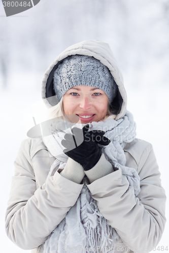 Image of Girl beeing cold outdoors in winter.