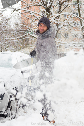 Image of Man shoveling snow in winter.