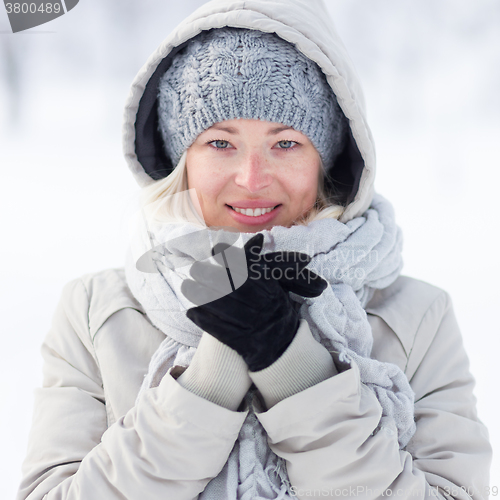 Image of Girl beeing cold outdoors in winter.