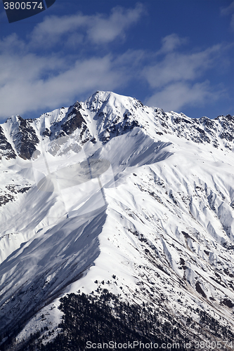 Image of Snowy mountain peak at sunny day