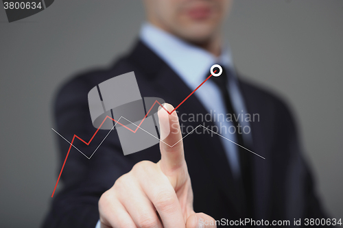 Image of Businessman Touching a Graph Indicating Growth