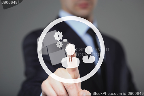 Image of business, technology and internet concept - businessman pressing button with mechanism icon on virtual screens