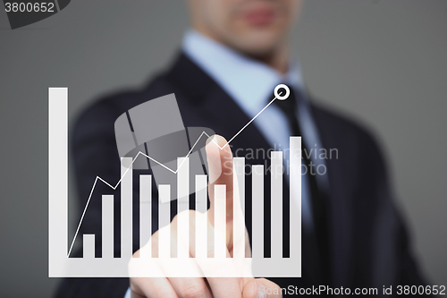 Image of Businessman Touching a Graph Indicating Growth