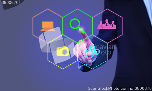 Image of businessman pressing Search button on virtual screens