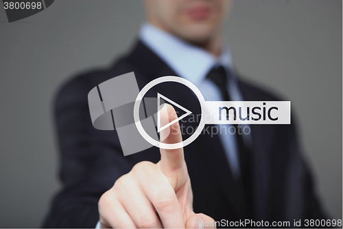 Image of Businessman pressing play music button 