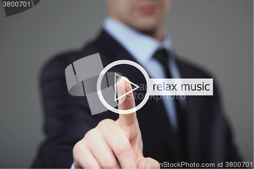 Image of Businessman pressing play relax music button 