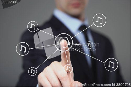 Image of Businessman pressing play music button. headphones and notes