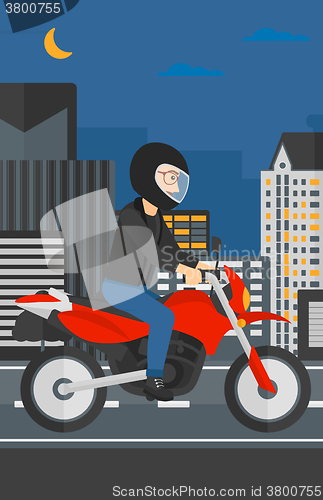 Image of Man riding motorcycle.