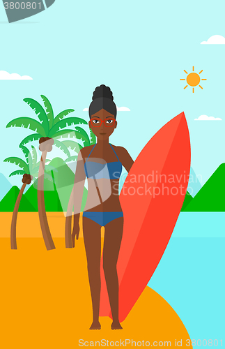 Image of Surfer holding surfboard.