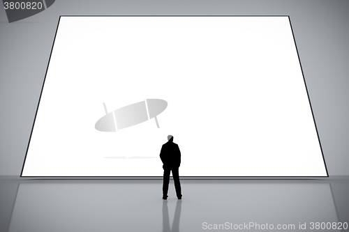 Image of man in front of a big white screen