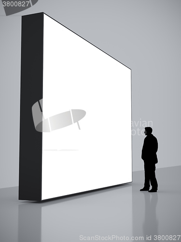Image of man in front of a big white screen