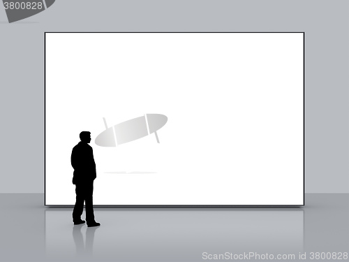 Image of man in front of a big white screen