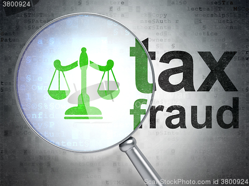 Image of Law concept: Scales and Tax Fraud with optical glass