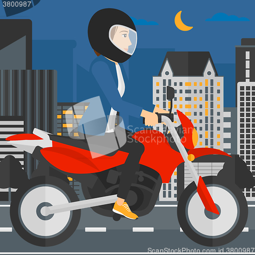 Image of Woman riding motorcycle.
