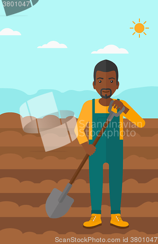 Image of Farmer on the field with shovel.