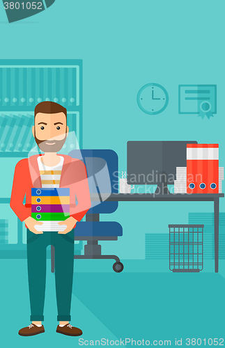 Image of Man holding pile of folders.