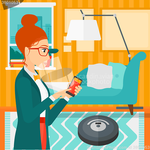 Image of Woman with robot vacuum cleaner.