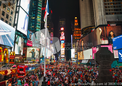 Image of Times square with people in the night