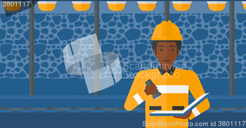 Image of Miner checking documents.