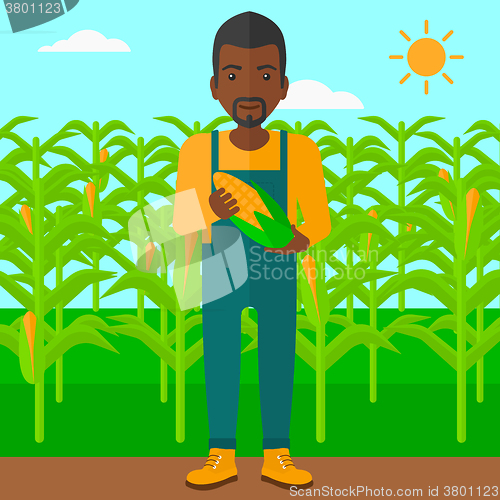 Image of Farmer holding corn.