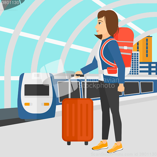 Image of Woman with suitcase on wheels and briefcase.