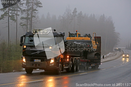 Image of Volvo FM Semi Hauls Crawler Excavator in Fog