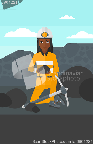 Image of Miner holding coal in hands.