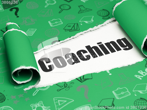 Image of Learning concept: black text Coaching under the piece of  torn paper